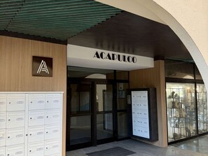 A building entrance with a sign reading 'ACAPULCO' and a series of mailboxes. - Apartment near sea, elevator - 4 guests (Argelès-sur-Mer)