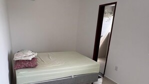 A room with a bed, a mirror, and a ceiling-mounted air conditioning unit. - Apartment in Jacumã (Balneário Novo Mundo, Praia de Jacuma, Conde)