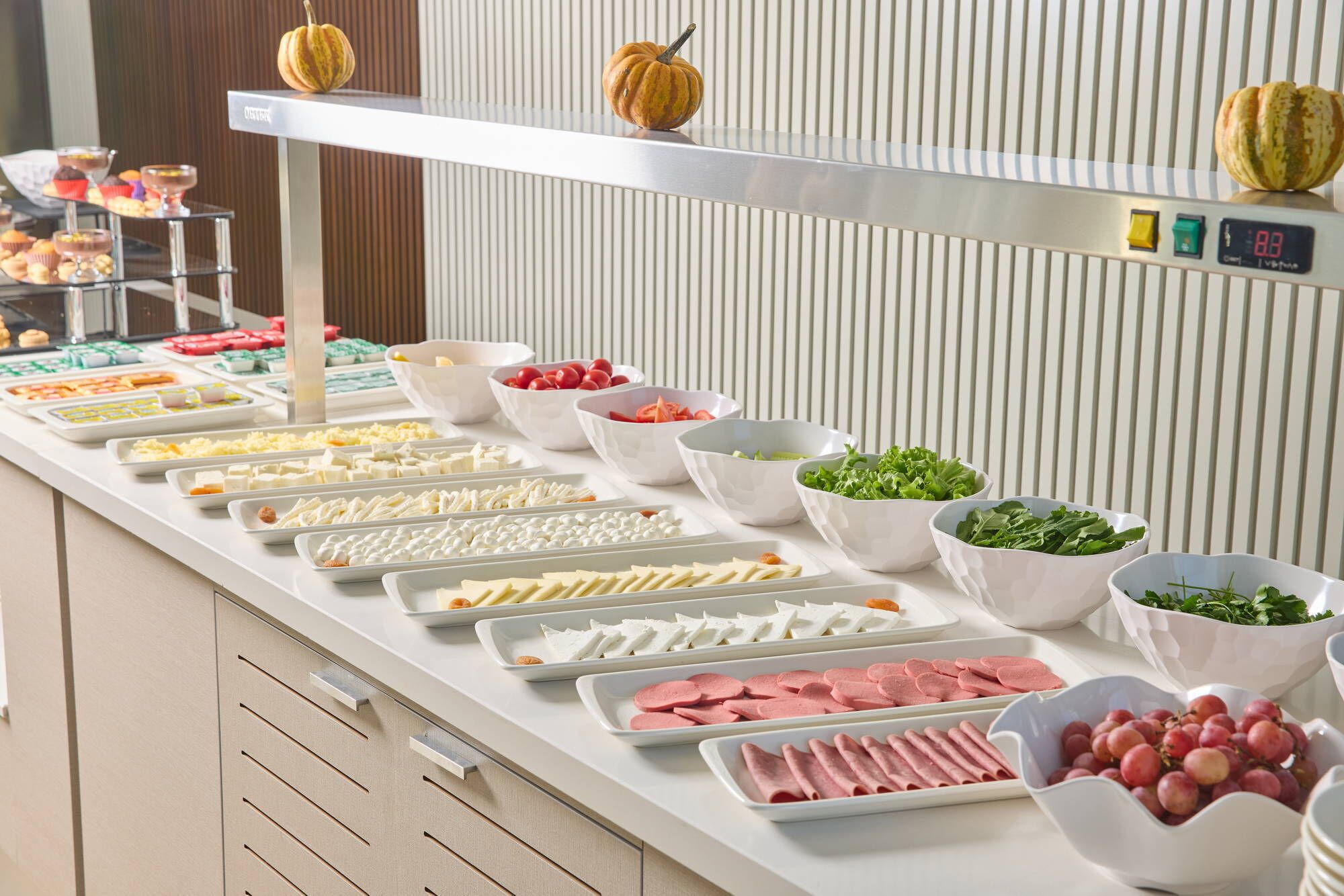 A buffet with various food items and a scale.