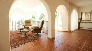 A spacious room with a balcony, a large window, and a bed with a nightstand. - Seven bedroom villa in Ojen near Marbella (Ojen)