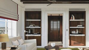 A modern living room with a sofa, coffee table, and shelves with books and decorative items. - Cipriani Punta Del Este  (Punta del Este)