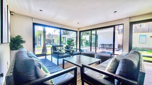 A modern outdoor living area with a sofa, chairs, and a table. - Cozy studio apartment in lovely Nairobi with amazing city views (Nairobi)