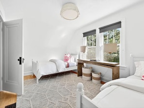 A bedroom with a bed, bedside table, lamp, window, and a view of greenery outside. - Spacious Linden Hills 4BD 2A Family Home (Minneapolis)