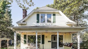 A two-story house with a porch, a chimney, and a mailbox. - Spacious Linden Hills 4BD 2A Family Home (Minneapolis)