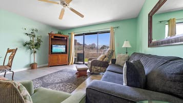Signature Condo, 1 Bedroom, Patio, Garden View | Living room | 35-inch flat-screen TV with satellite channels