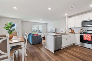 A modern kitchen with white cabinets, a stainless steel oven, and a built-in dishwasher. - "Surfside Beach Oasis" (Myrtle Beach)