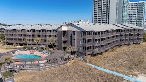 A multi-story hotel with balconies, a swimming pool, and a beachside location. - Tequila at Tilghman Resort (North Myrtle Beach)