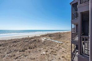 A beach view with a building on the right. - Tequila at Tilghman Resort (North Myrtle Beach)