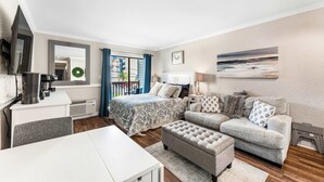 A modern bedroom with a bed, a sofa, a coffee machine, and a TV. - "Dreams By The Sea" at dunes village (Myrtle Beach)