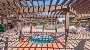 A wooden deck with a pool, lounge chairs, and a pergola structure. - "Soul Soother" at Tilghman (North Myrtle Beach)