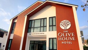 A modern building with a sign reading 'The Olive House Hotel.' - The Olive House Hotel (Khon Kaen)