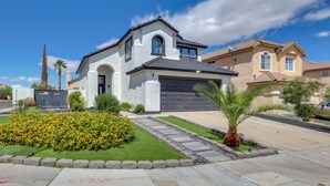 A residential house with a garage, a well-maintained lawn, and a clear sky. - 6 Mi to Strip & Chinatown! Poolside Desert Escape (Las Vegas)