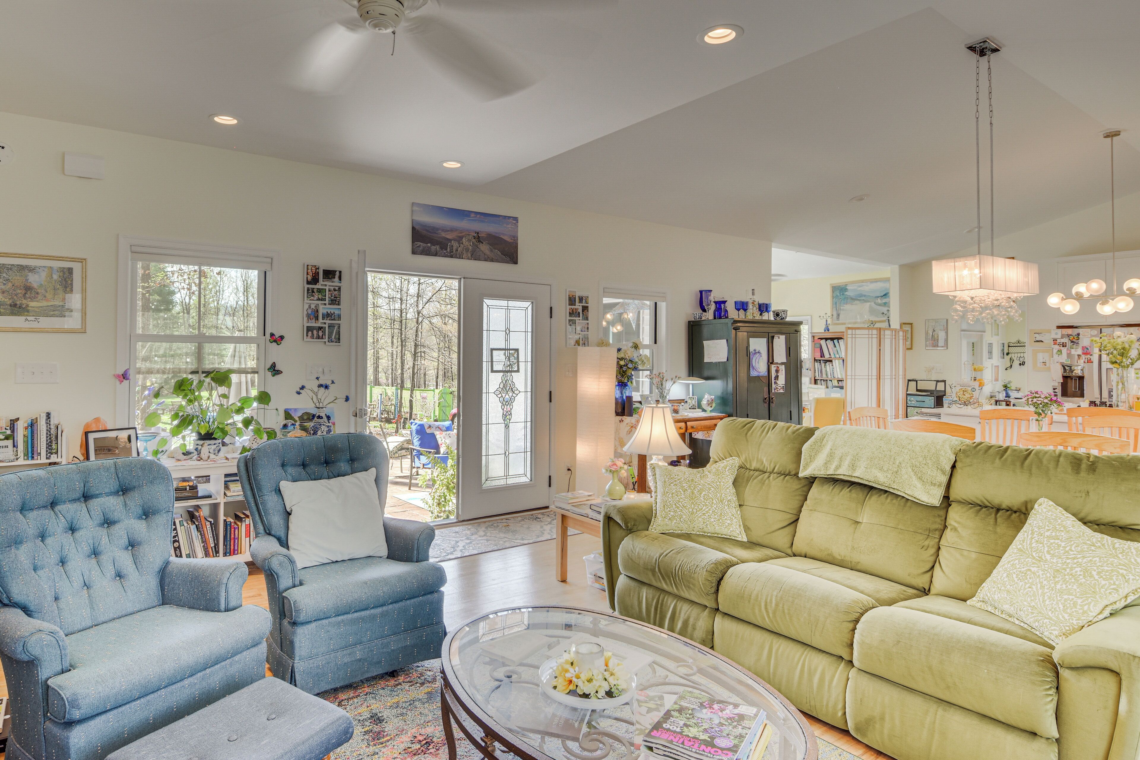 A spacious living room with a large sofa, armchairs, and a coffee table.