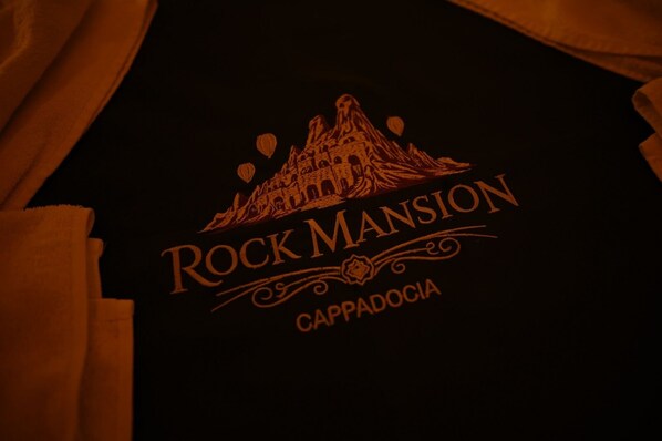 A black t-shirt with the text 'Rock Mansion Cappadocia' and a mountain graphic.