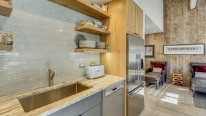 A modern kitchen with a stainless steel sink, a dishwasher, and a built-in refrigerator. - Walk to Town & Slopes, Views, SPA & Sauna Access (Ketchum)