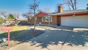 A residential house with a garage, a mailbox, and a driveway. - Hot Tub, Pool Table, Fireplace, Sunny Patio (Arvada)