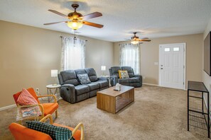 A living room with two sofas, a coffee table, and ceiling fans. - Great for Military Families! Quiet Columbia Home (Blythewood)
