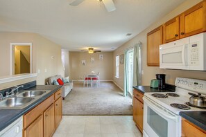 A kitchen with a stove, microwave, and double sink. - Great for Military Families! Quiet Columbia Home (Blythewood)