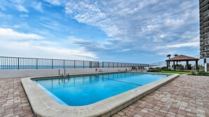 A rectangular pool with a tiled edge, surrounded by a brick patio. - Pool Access! Oceanfront Daytona Beach Shores Gem (Daytona Beach Shores)