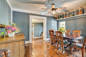A dining area with a wooden table and chairs, a ceiling fan, and a view into another room. - Surrounding Pasture Views! Peaceful Escape in Iuka (Iuka)