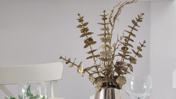 A dining table set with white plates, clear wine glasses, and a decorative vase with gold foliage. - Birmingham Contractor Stay, 5 Bed, Private Parking, Near M6, Groups (Birmingham)
