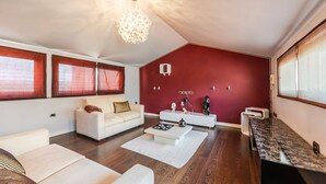 A modern living room with a white sofa, a coffee table, and a red accent wall. - Tranquility Villa With Pool Private Garden BBQ (Farkë)