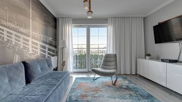 Family Apartment, City View | Living area | 45-inch TV with cable channels