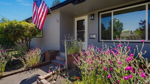 A house with a flag, steps, and a window.