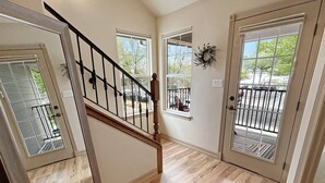 A staircase leading to a landing with a view of the outside. - Victorian Chateau Retreat 3 Bedroom Townhouse (Grand Junction)