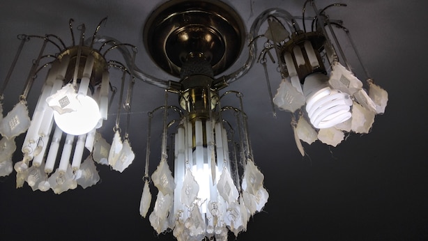 A chandelier with multiple light fixtures and crystal decorations. - Cosy Facebook Headquarters. I own them cause I said I did. Please refer to me TR (Fairhaven)