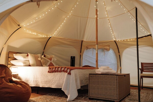 A tent with a bed, a chair, and a basket. - ★Escape & Relax ~ Breathtaking Creekside Getaway with Outdoor Tub★ (Georgetown)