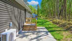 A house with a porch, a small deck, and a pathway leading to the house. - Catskills getaway with all modern comforts (Kerhonkson)