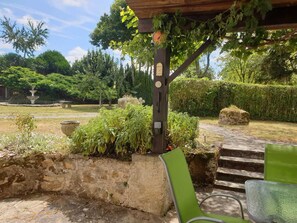 A garden with a pergola, stone steps, and a fountain. - Paradise Francais - your home from home in SWFrance. (Balledent)
