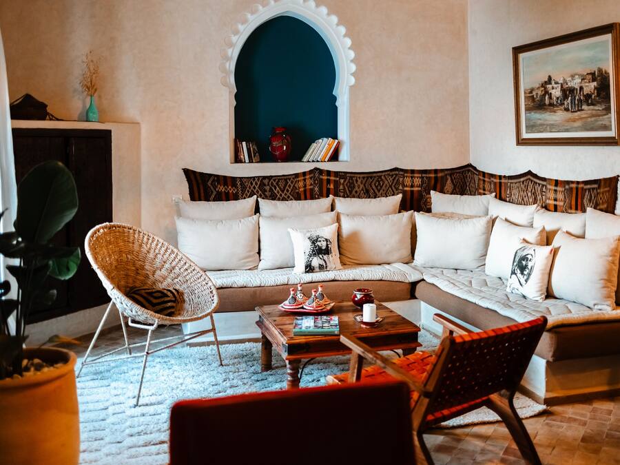 A living room with a sofa, chairs, a coffee table, and a bookshelf.