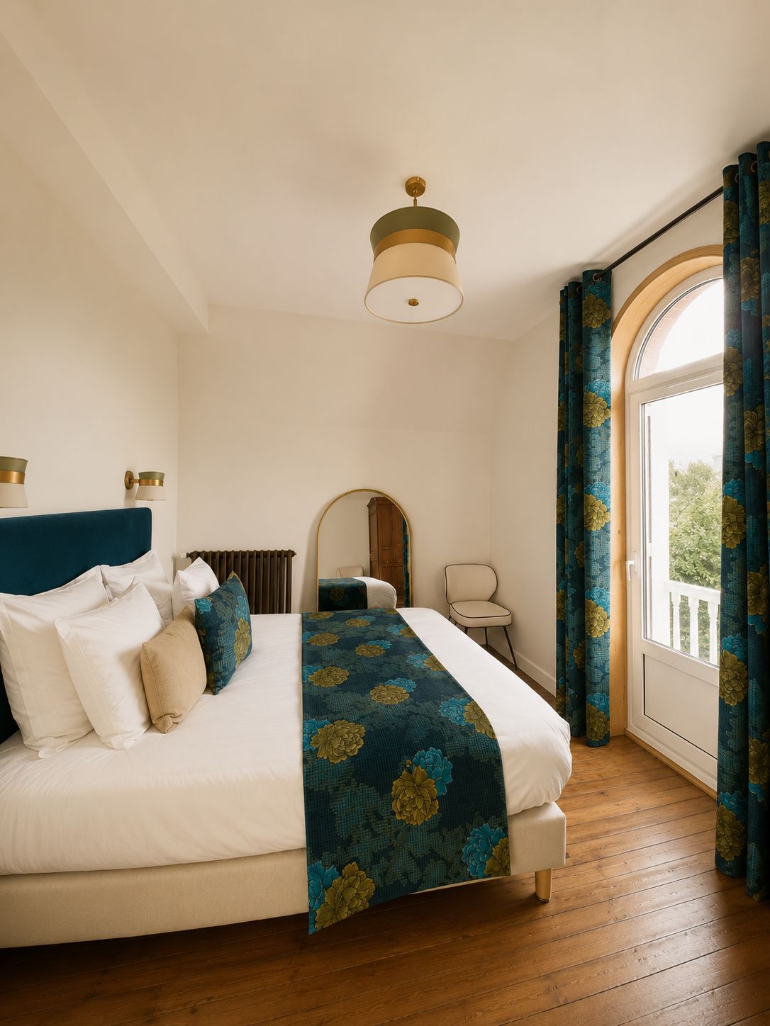 A bedroom with a bed, a bedside table, a chair, a mirror, and a window with curtains.