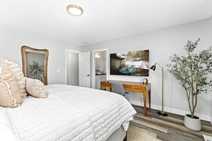 A bedroom with a bed, desk, chair, and a large window. - Luxe Meridian Retreat •1K+3Q beds • 600+ WiFi • 3 Desks • Games • Prime Location (Meridian)