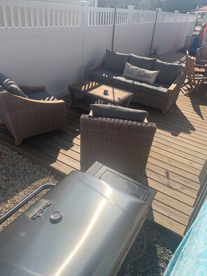 A deck with wicker furniture, a grill, and a poolside area. - Ocean side 6 houses to the beach; 4 bed with full SUNSET views (Beach Haven)