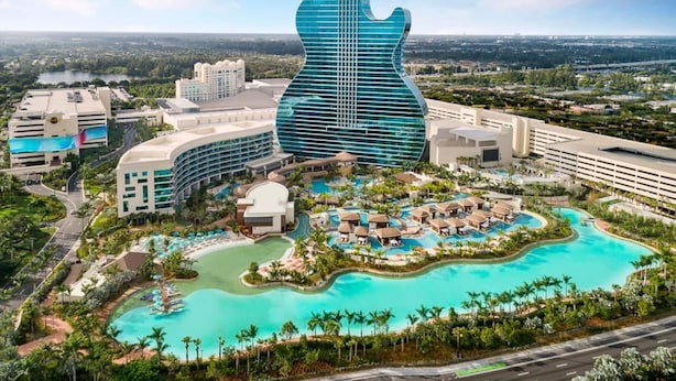 A resort with a guitar-shaped building, multiple swimming pools, and lush landscaping. - Home Near Hard Rock w/ BBQ & Pool Table (Opa-locka)