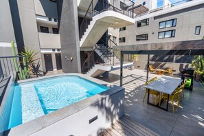 A rooftop pool with a modern design, a staircase, and outdoor seating area. - The Cedar 202 (Cape Town)
