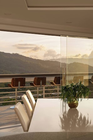 A modern dining area with a glass partition, a table, and four chairs. - Luxurious 4-bedroom House in Alajuela, Costa Rica (Guacima)