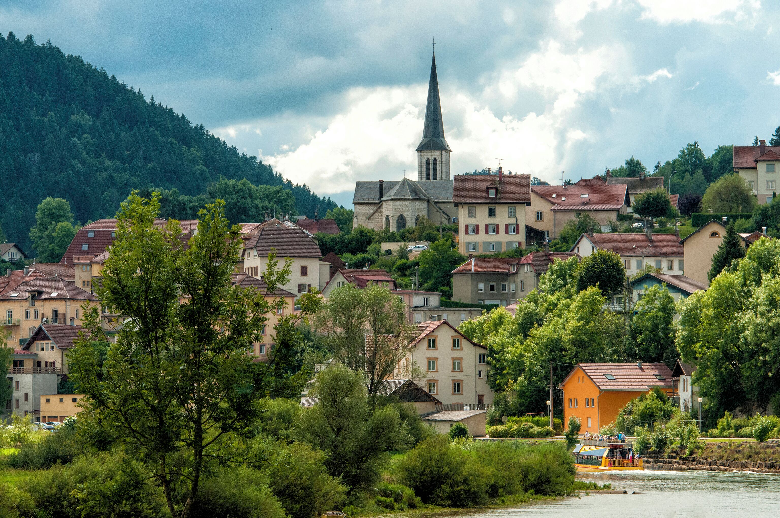 Une ville qui se distingue par sa grande église, ses immeubles d’habitation et la rivière qui la traverse.
