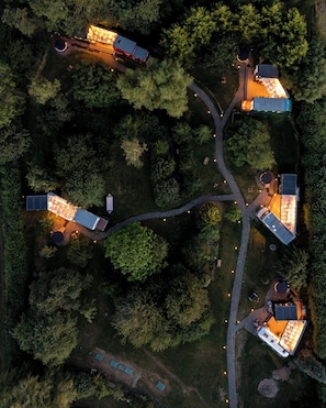 An aerial view of a residential area with multiple houses connected by pathways, surrounded by dense trees. - Sleeps 2 - Hot Tub - Pet Friendly - Peggysue (Skegness)