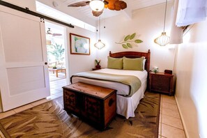 A bedroom with a bed, bedside table, nightstand, and a chest of drawers. - Kona Mansions#b217 Beautiful Unit With Ocean View! (Kailua-Kona)