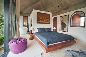 A bedroom with a large bed, a purple bean bag, and a painting on the wall. - 3BR villa in tranquil Hoi An Vietnam, private pool, pick-up&breakfasts inclusive (Đà Nẵng)