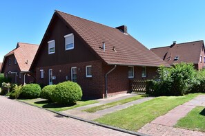 Exterior - The Nordlys vacation home on the North Sea offers modern comfort with a wood-burning stove, south-west-facing terrace and fenced garden - perfect for families and couples. (Hooksiel)