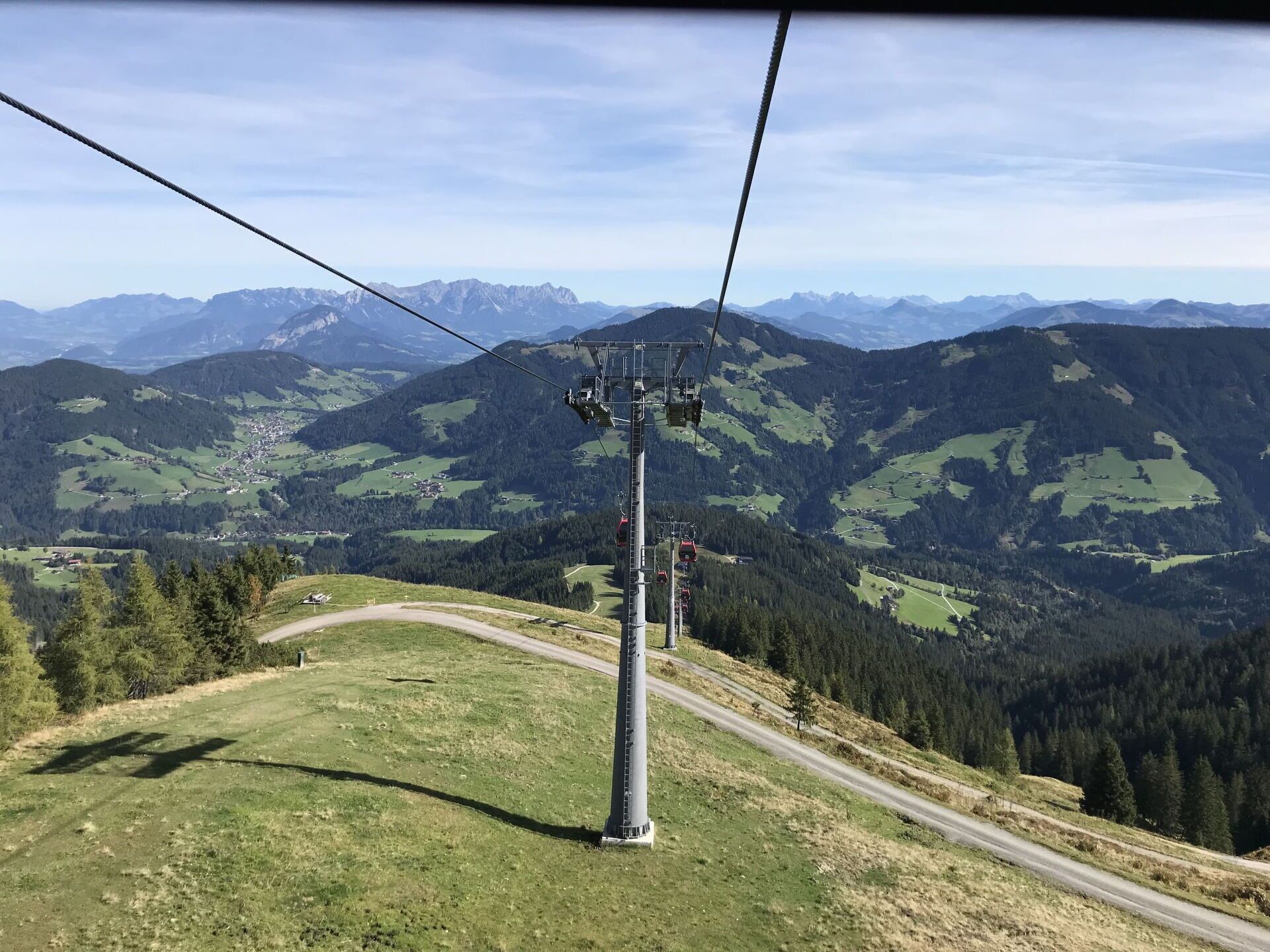 A cable car system with a clear view of the surrounding mountainous landscape.