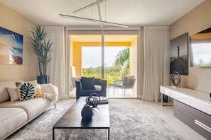 A modern living room with a sofa, coffee table, and a balcony with outdoor furniture. - Cozy 1-bedroom apartment in amazing Miami with AC (Miami)