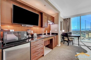 A modern kitchen with a flat-screen TV, a coffee maker, a toaster, and a blender. - MGM Signature (Las Vegas)