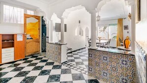 A hotel lobby with a checkered floor, white walls, and patterned tile walls. - Lovely 2-El Jadida City Center Apt – Ideal Spot, Beach View & WiFi (El Jadida)
