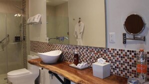 A bathroom with a white sink, a mirror, a towel rack, and a shower area. - TRES79 Hotel Boutique Orizaba - Deluxe Room, 1 King (Orizaba)